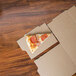 A slice of pizza on a GreenBox pizza box.