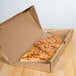 A cheese pizza in a GreenBox pizza box on a table.