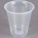 A Dart ClearPro clear plastic cup on a gray surface.