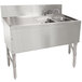 An Advance Tabco stainless steel underbar sink with 2 compartments, a drainboard, and a deck mount faucet.