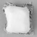 A white square object of Alto-Shaam 14 Gram Cleaning Tabs on a white surface.