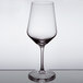 A close-up of a Stolzle all-purpose wine glass with a white rim.