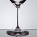 A Stolzle Revolution wine glass filled with wine on a table.