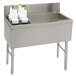 A stainless steel Advance Tabco ice bin and bottle storage combo unit with a bottle holder on a counter.