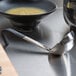 A Vollrath Jacob's Pride ladle with a black handle on a counter.