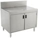 A stainless steel Advance Tabco Prestige Series drainboard cabinet with doors over a drain.
