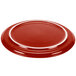 A red Fiesta china pizza tray with a white rim.