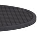An American Metalcraft oval black silicone trivet with a square grid pattern.