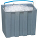 A gray Follett ice storage bin full of ice with a blue handle.