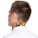 A man wearing a multi pepper patterned Intedge chef neckerchief with a colorful collar.