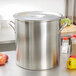 A large silver Vollrath pot cover on a counter.