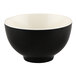 An Elite Global Solutions Karma melamine bowl with a black exterior and a white interior and rim.