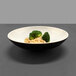 An Elite Global Solutions two-tone melamine bowl with rice and broccoli on a table.