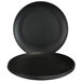 An Elite Global Solutions black melamine plate on a table with two more plates.