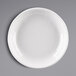 A white Elite Global Solutions melamine bowl with a white pebble rim on a white surface.