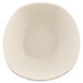 An irregular-shaped papyrus-colored melamine bowl with a white background.