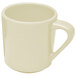 A close-up of a white coffee mug with a handle.