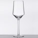 A clear GET Tritan plastic wine glass with a stem on a table.