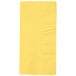 A yellow square Creative Converting paper napkin on a white background.