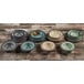A group of Elite Global Solutions vanilla crackle pasta/soup bowls stacked on a wood table.