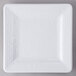 A white square Elite Global Solutions melamine plate with a white pebble rim on a gray surface.