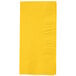 A yellow rectangular napkin with a square pattern.