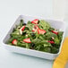 A white GET Midtown melamine bowl filled with a salad of strawberries, blueberries, and spinach.