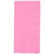 A pink rectangular paper napkin with a white border.