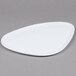 A white triangle shaped melamine plate with a white rim.