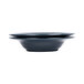 An Abyss and Lapis two-tone melamine bowl on a table with two plates on top.