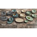 A table with a group of Elite Global Solutions Cameo Blue Crackle melamine plates and bowls on a wood surface.