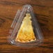 A piece of pie in a 7" clear plastic container with a low dome lid.
