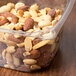 A 16 oz. Square Recycled PET deli container filled with mixed nuts.