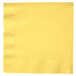 A yellow paper napkin with a white border.