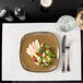 A plate of salad and fruit on a Snap Drape ivory placemat.