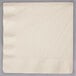 A close up of an ivory Creative Converting paper dinner napkin with a corner showing.