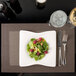 A white plate of salad with raspberries and nuts on a Snap Drape Taos Beige placemat.