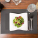 A white plate of salad with raspberries and nuts on a Snap Drape Taos Charcoal placemat.