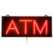 A red LED sign with the word "ATM" in red lights.