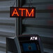 A white sign with red LED lights that says "ATM" and has a red LED border.