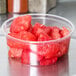 A Choice clear plastic deli container filled with watermelon chunks.