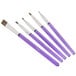 A group of purple Wilton cake decorating brushes with one black handle.