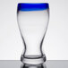 A clear Libbey Pilsner glass with a cobalt blue rim.