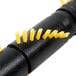 A black pipe with yellow brushes on it.