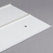 A white plastic sheet with a hole.
