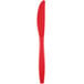 A red Creative Converting heavy weight plastic knife with a white background.