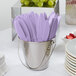 A bucket filled with Creative Converting Luscious Lavender purple plastic knives inside.