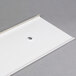 A white plastic sheet with a hole in it.