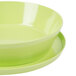 A lime green melamine bowl and plate on a white background.
