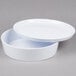 A white round melamine container with a lid.